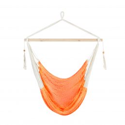 Orange hanging chair CARINA with a white suspension rod and decorative tassels.