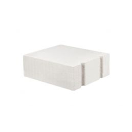White rectangular construction block with smooth surfaces and longitudinal grooves along one edge.