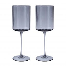 Two grey wine glasses with tall cylindrical bowls and long stems, made of transparent glass with vertical stripes.