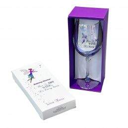 Transparent wine glass with silver text and a fairy illustration, approximately 22.3 cm tall, presented in a purple gift box next to a white box with a matching design.