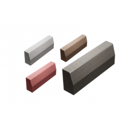 Four trapezoidal curb stones in various colors: gray, brown, red, and dark gray. The stones have smooth surfaces and come in different sizes.
