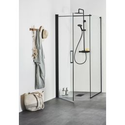 Image of the Noro shower corner 'Frost Concept' featuring clear sliding glass doors and a black frame. A gray wall hook with a towel and bag is visible.