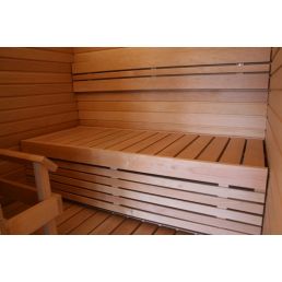 Sauna interior featuring horizontal wooden slats and seats with backrests.