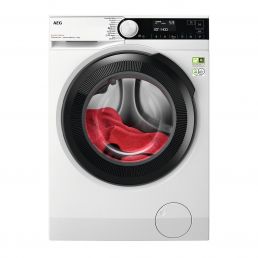 White front-loading washing machine with a black frame and transparent door, red garment inside. The control panel is on the top right.