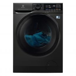 Black front-loading washer-dryer with a large glass door and a top control panel, with blue laundry visible inside.