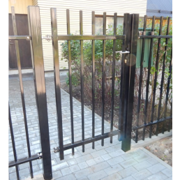 Black metal pedestrian gate with vertical bars. Reinforced handle and a simple locking mechanism.