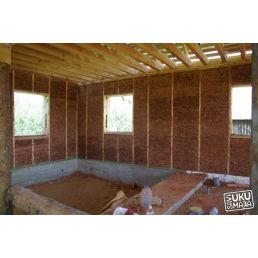The framing stage of construction using lightweight and massive clay blocks. The image shows unfinished walls and an uninstalled roof.