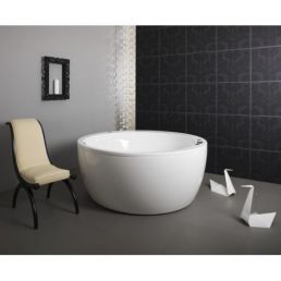 Oval white bathtub for home use, set against a black-tiled wall with a soft cream-colored chair on the left.