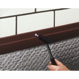 Black sealing strip for foundation Delta-NB, 2 meters long, installed under a window.